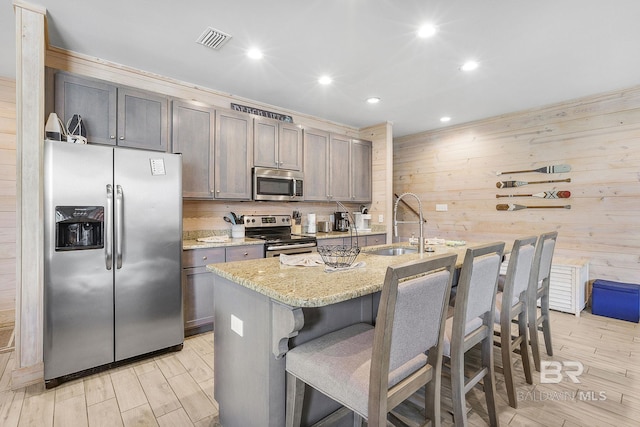 487 E 1st Ave Unit F, Gulf Shores, AL 36542 - kitchen featuring a kitchen breakfast bar, visible vents, recessed lighting, a sink, and stainless steel appliances
