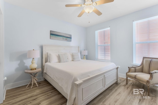 487 E 1st Ave Unit F, Gulf Shores, AL 36542 - bedroom featuring baseboards, light wood-type flooring, and ceiling fan