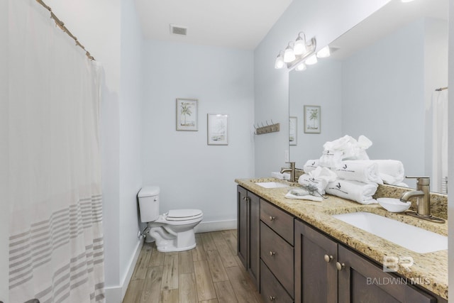 487 E 1st Ave Unit F, Gulf Shores, AL 36542 - full bath featuring toilet, wood finished floors, a sink, and baseboards