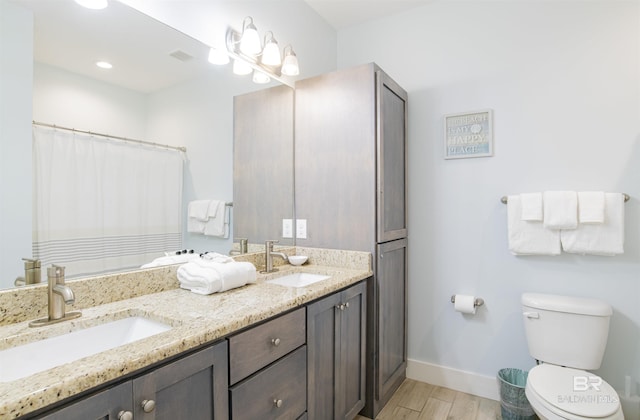 487 E 1st Ave Unit F, Gulf Shores, AL 36542 - full bath featuring toilet, wood finished floors, a sink, and baseboards
