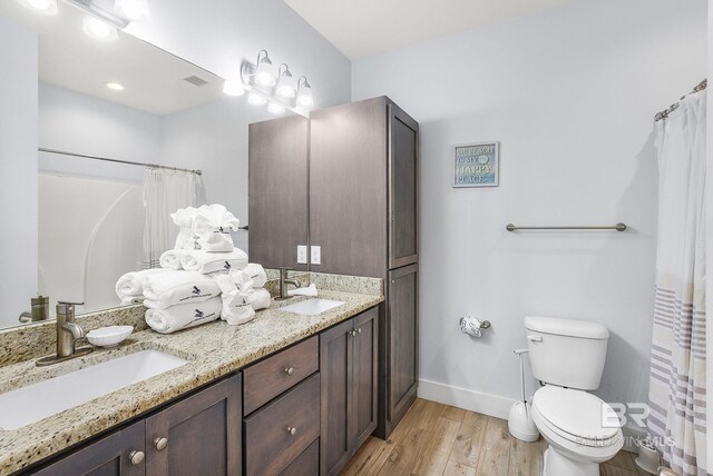 487 E 1st Ave Unit F, Gulf Shores, AL 36542 - bathroom featuring baseboards, a sink, toilet, and wood finished floors