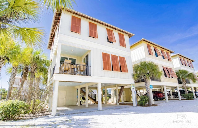 487 E 1st Ave Unit F, Gulf Shores, AL 36542 - exterior space featuring a carport and stairs