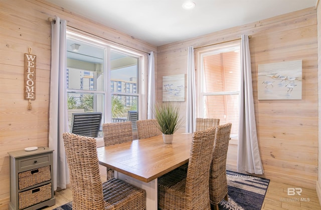 487 E 1st Ave Unit F, Gulf Shores, AL 36542 - dining space featuring wooden walls and light wood-type flooring