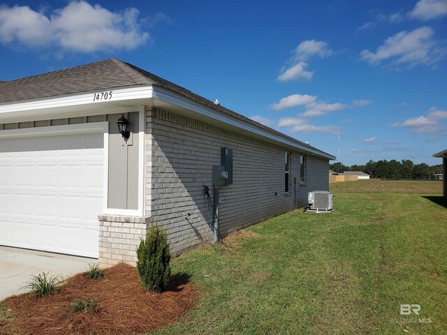 view of property exterior with a garage, central AC unit, and a lawn