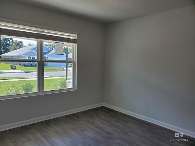 empty room featuring dark wood-type flooring