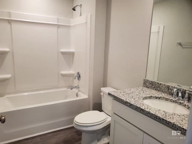 full bathroom with vanity, hardwood / wood-style flooring, toilet, and shower / washtub combination