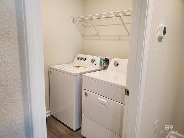 clothes washing area featuring washing machine and dryer and dark wood-type flooring