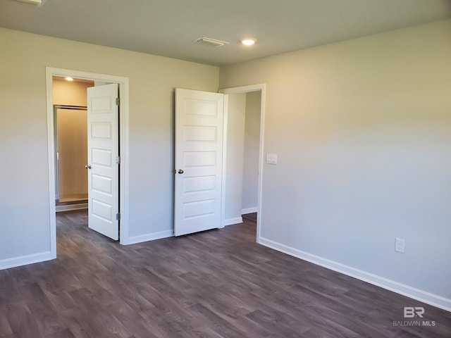 unfurnished bedroom with dark wood-type flooring