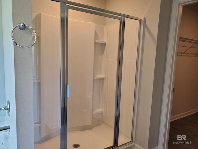 bathroom featuring a shower with door