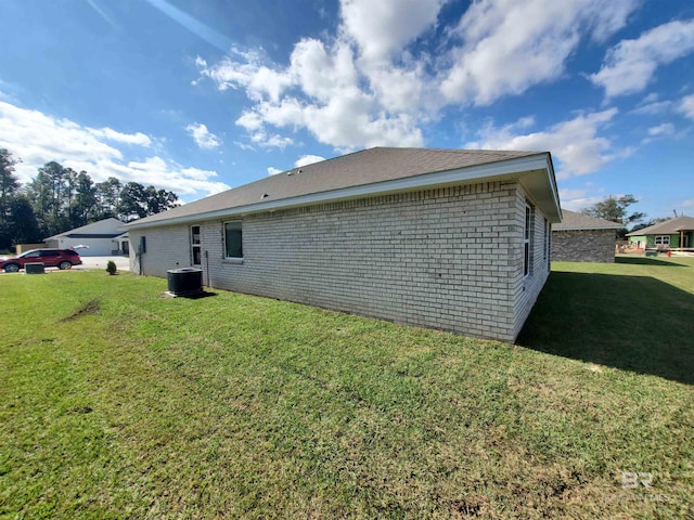 view of side of property with a lawn and cooling unit