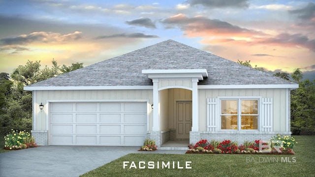 view of front of house featuring a garage and a yard