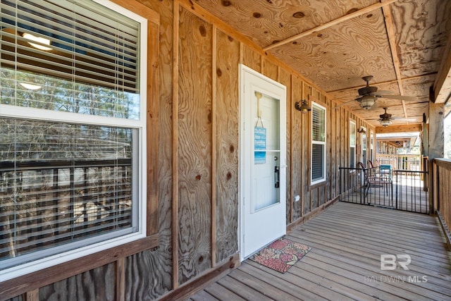 wooden deck with a ceiling fan