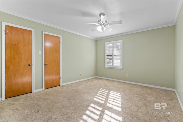 unfurnished room featuring light carpet, ceiling fan, and ornamental molding