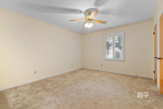 carpeted spare room featuring ceiling fan and ornamental molding