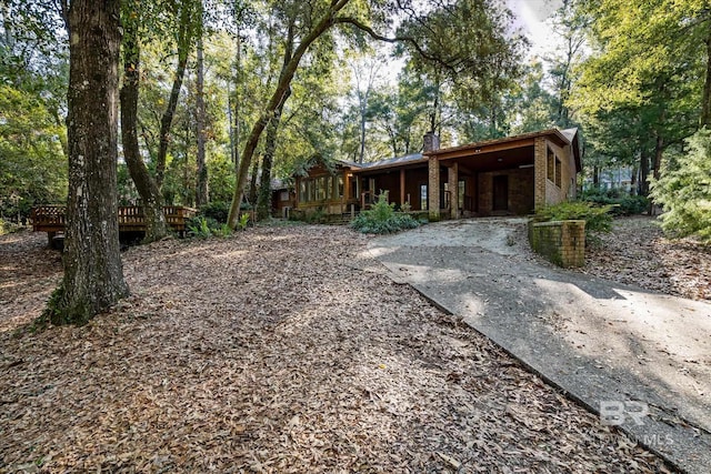 view of yard featuring a deck and a carport