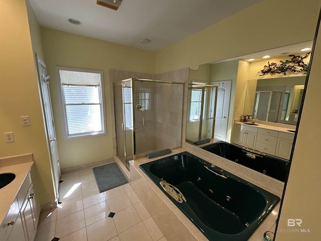 bathroom featuring vanity, baseboards, a shower stall, tile patterned floors, and a tub with jets