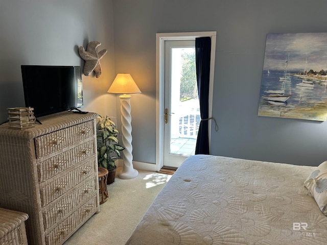 bedroom with carpet floors, access to outside, and baseboards