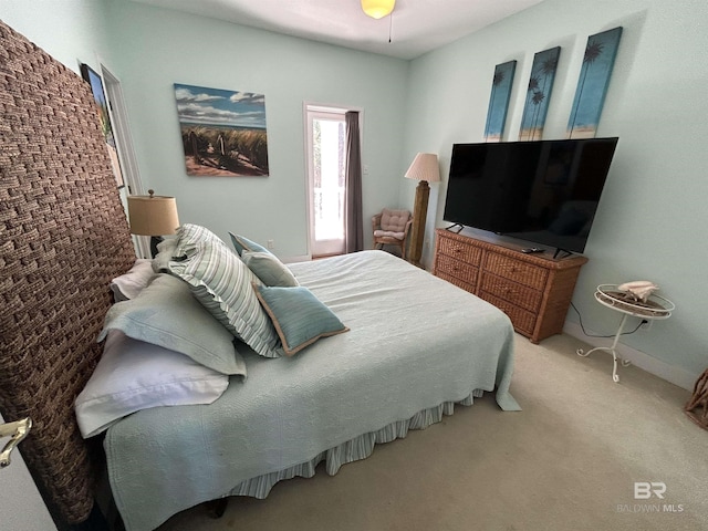 bedroom featuring light carpet