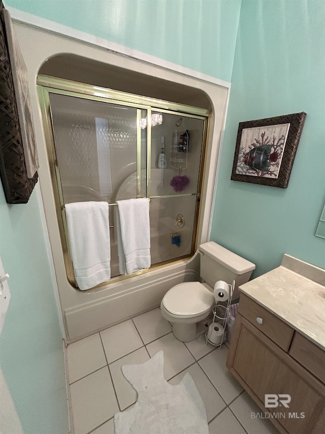 full bath featuring enclosed tub / shower combo, vanity, toilet, and tile patterned floors