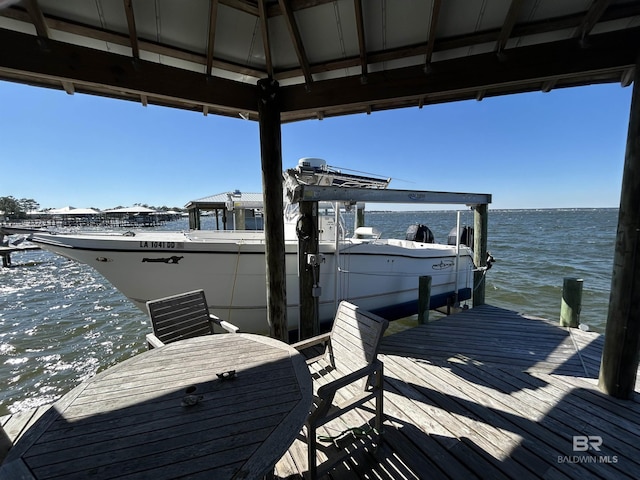 dock area with a water view and boat lift