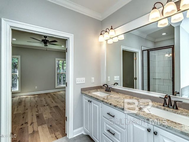 bathroom with ornamental molding, wood finished floors, and a sink