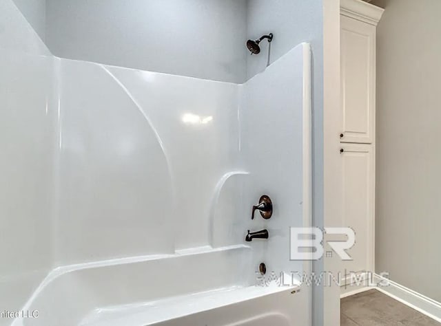 bathroom featuring tile patterned floors and bathtub / shower combination