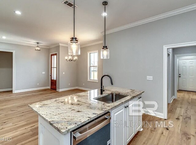 kitchen featuring visible vents, ornamental molding, stainless steel dishwasher, white cabinets, and a sink