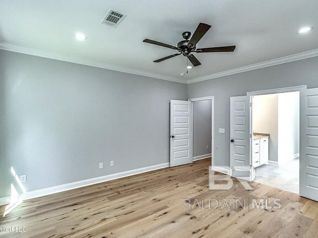 unfurnished bedroom with visible vents, light wood-style flooring, recessed lighting, crown molding, and baseboards