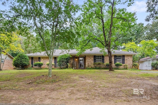 single story home featuring brick siding and a front yard