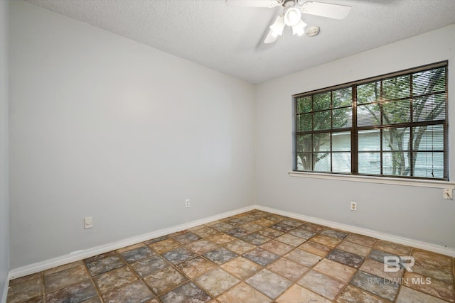 spare room featuring a textured ceiling and ceiling fan