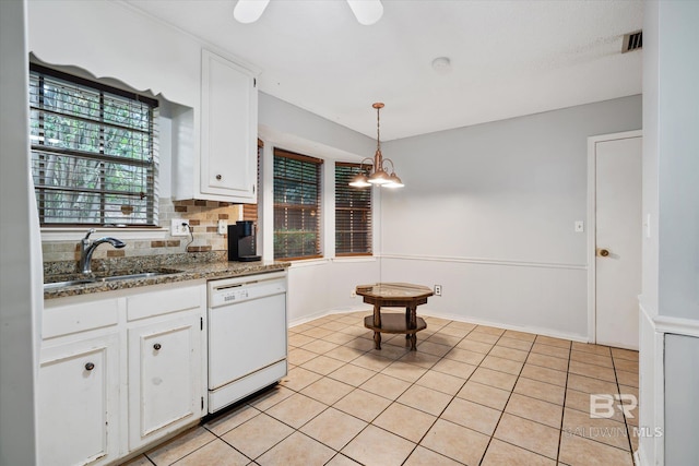 kitchen featuring visible vents, a sink, white cabinets, white dishwasher, and hanging light fixtures