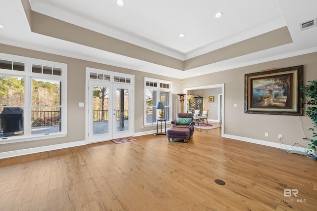 unfurnished room with a tray ceiling, french doors, visible vents, and ornamental molding