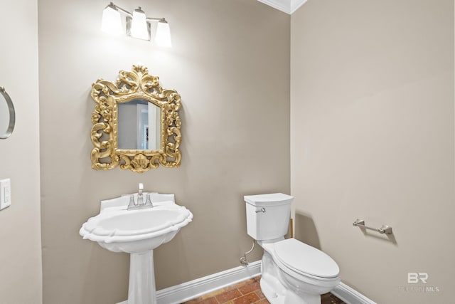 half bathroom featuring toilet and baseboards