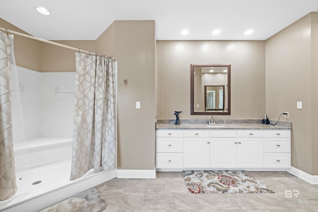 full bathroom featuring recessed lighting, baseboards, a stall shower, and vanity