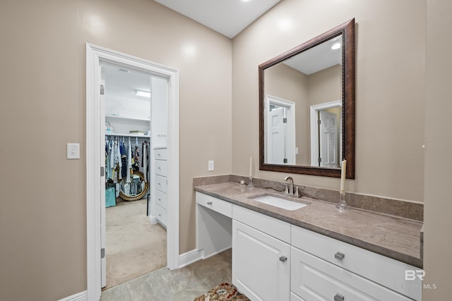 bathroom with vanity and baseboards