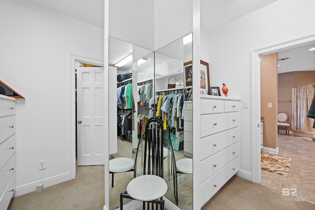 walk in closet with visible vents and carpet floors