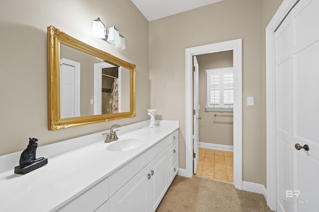 bathroom featuring baseboards, vanity, and tile patterned flooring