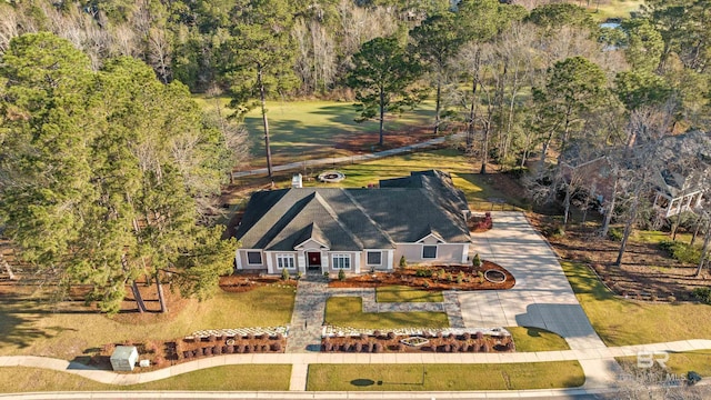 birds eye view of property featuring a view of trees