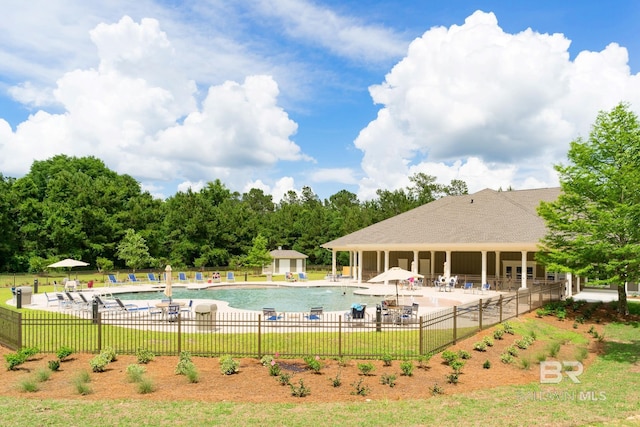community pool featuring fence and a patio area