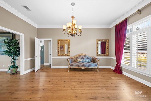 unfurnished room featuring visible vents, baseboards, ornamental molding, and light wood finished floors