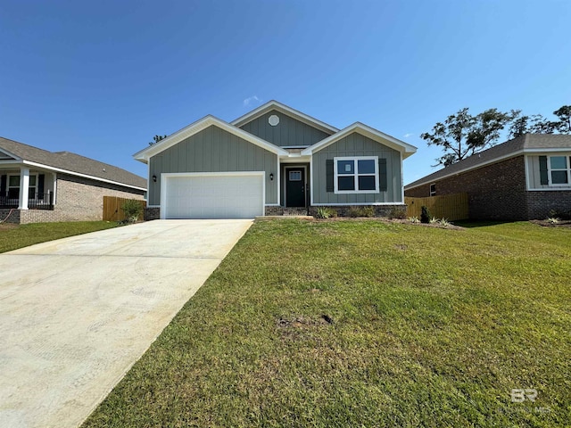 view of front of property with concrete driveway, board and batten siding, a front yard, and fence