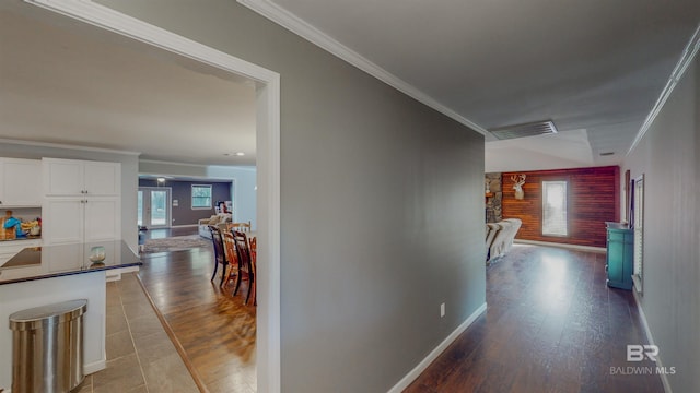 corridor with tile patterned flooring and crown molding