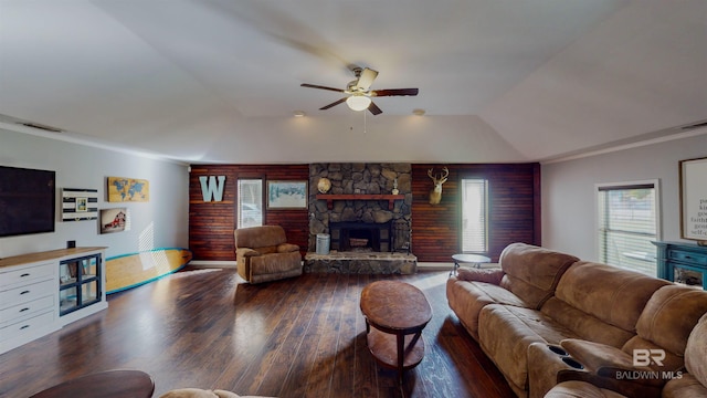 living room featuring lofted ceiling, a fireplace, dark hardwood / wood-style floors, ceiling fan, and crown molding