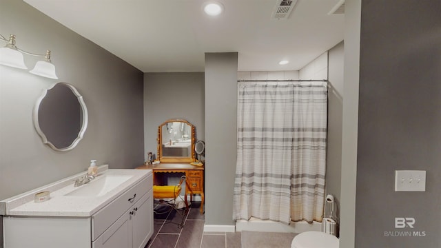 bathroom featuring toilet, vanity, tile patterned floors, and a shower with shower curtain