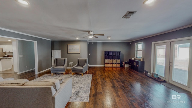 living room with ceiling fan, dark hardwood / wood-style floors, ornamental molding, and french doors