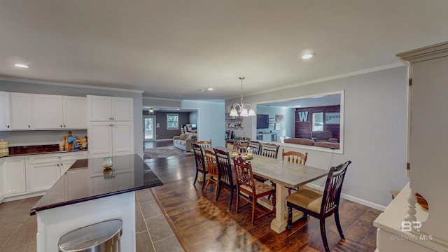 dining area featuring a chandelier, dark hardwood / wood-style flooring, and ornamental molding