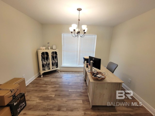 office with baseboards, dark wood-style floors, and a notable chandelier