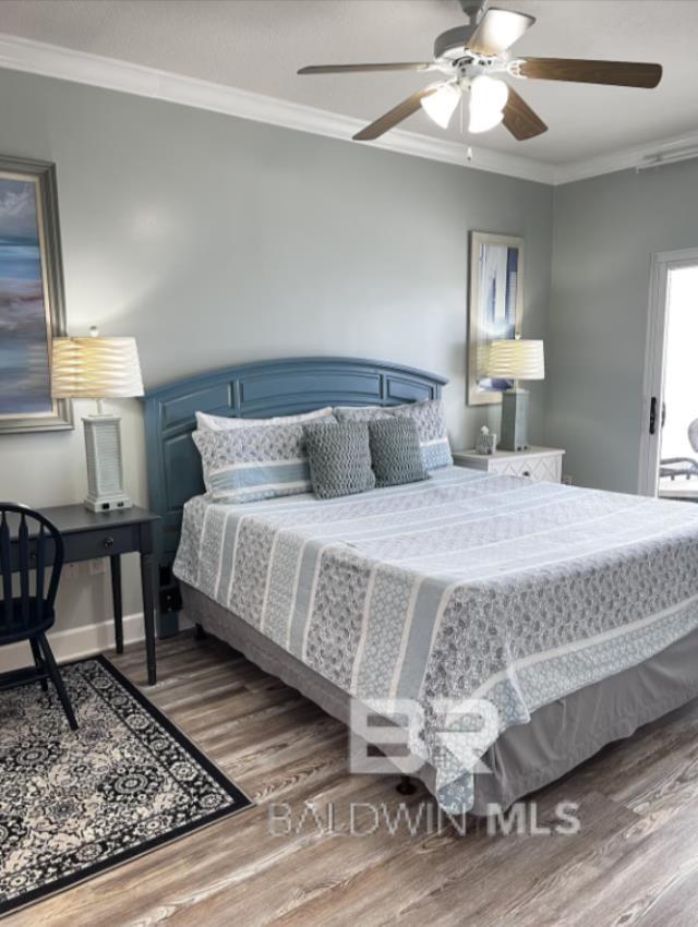 401 E Beach Blvd Unit 507, Gulf Shores, AL 36542 - bedroom featuring ornamental molding, wood finished floors, a ceiling fan, and baseboards