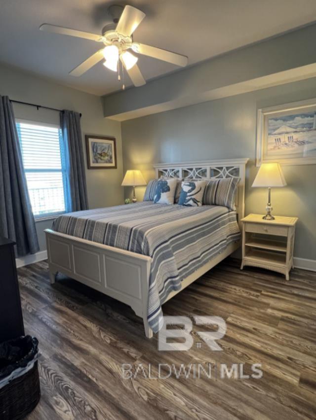 401 E Beach Blvd Unit 507, Gulf Shores, AL 36542 - bedroom with dark wood-style flooring, baseboards, and a ceiling fan