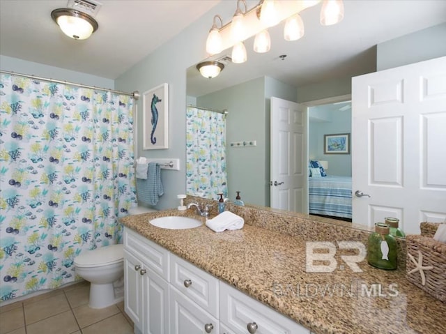 401 E Beach Blvd Unit 507, Gulf Shores, AL 36542 - full bath with toilet, vanity, tile patterned flooring, and a shower with shower curtain